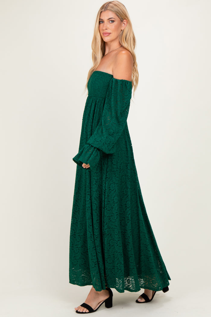 woman wearing a green off-the-shoulder lace maxi dress with long sleeves and a flowy skirt