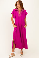 woman wearing a bright pink maxi dress with a collar and side pockets, standing against a white background
