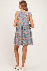 woman wearing a blue floral maternity dress with a flowy, A-line silhouette and sleeveless design, showing her back