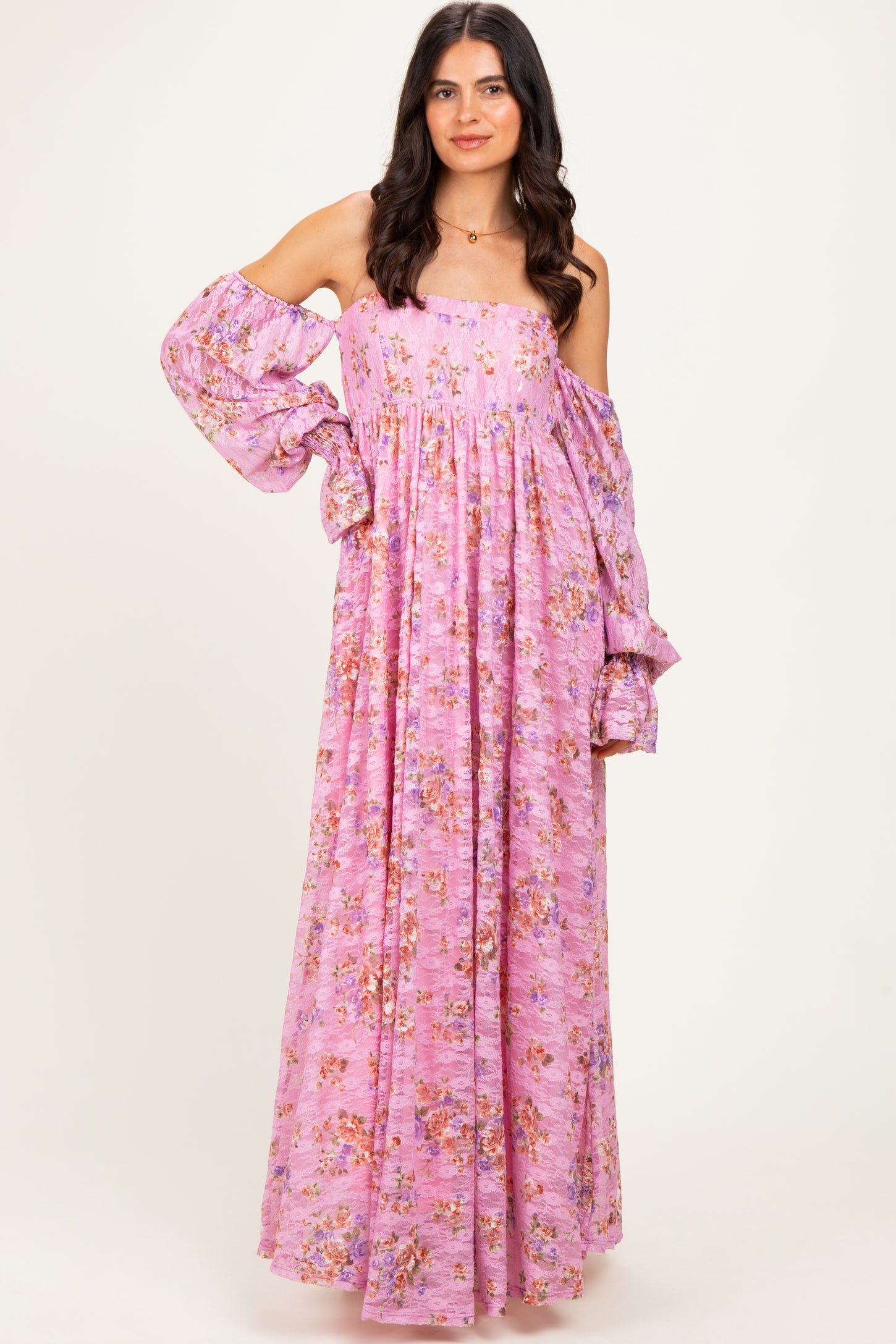 woman wearing a lavender off-shoulder maxi dress with floral print and bell sleeves