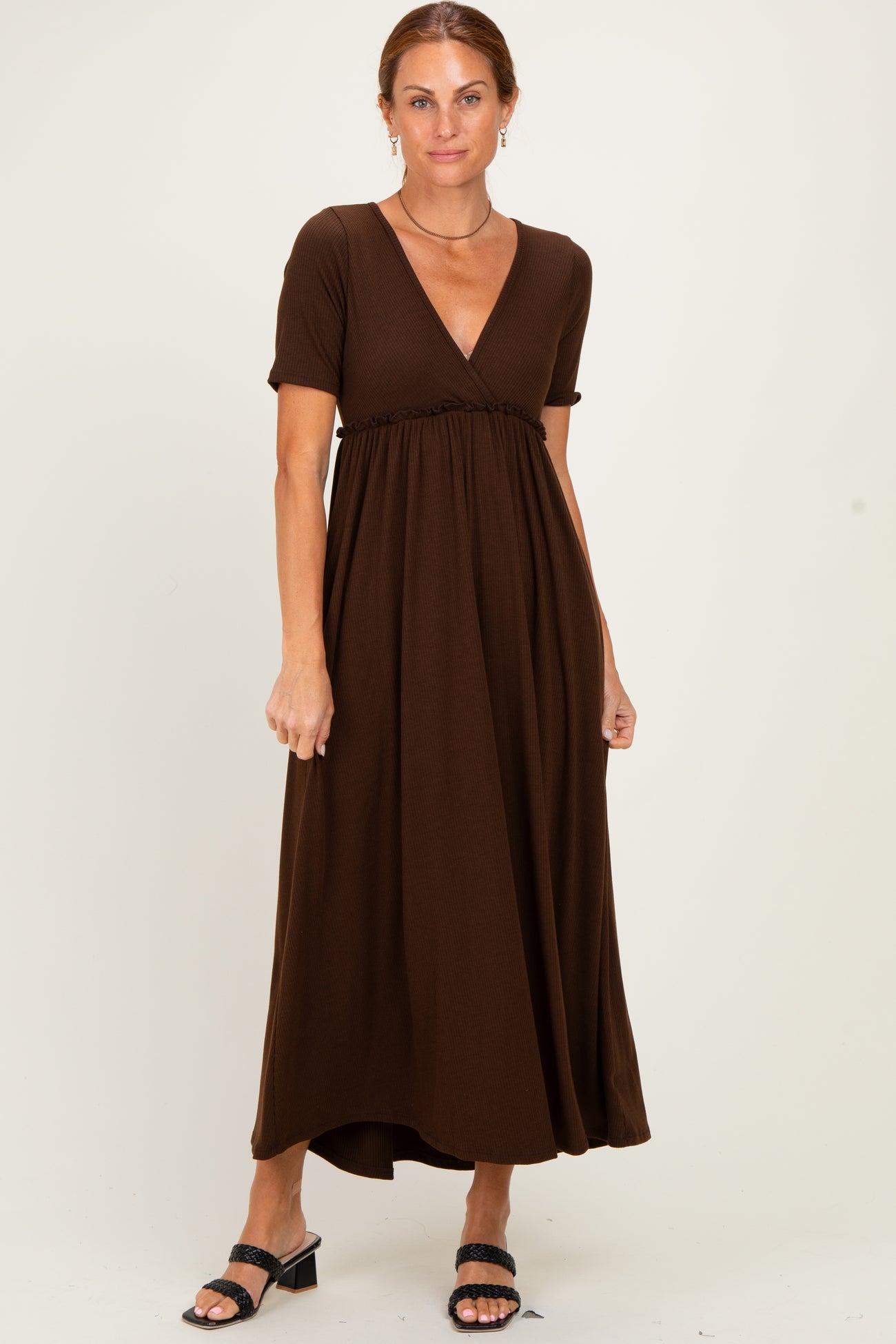 woman wearing a brown short sleeve maxi dress with a v-neck and smocked waist detail
