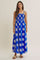 woman wearing a blue floral maxi dress with spaghetti straps and a smocked bodice
