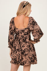 woman wearing a brown floral print dress with puff sleeves and a low back