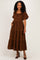 woman wearing a brown puff sleeve maxi dress with tiered layers and pockets