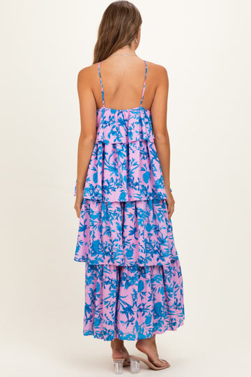 woman wearing a pink and blue floral maternity maxi dress with layered tiers and thin straps