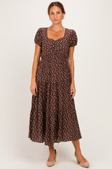 woman wearing a brown polka dot midi dress with short sleeves and a square neckline