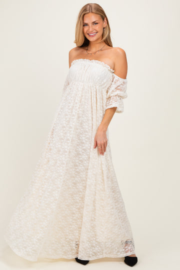 woman wearing a white off-the-shoulder maxi dress with lace overlay and short sleeves