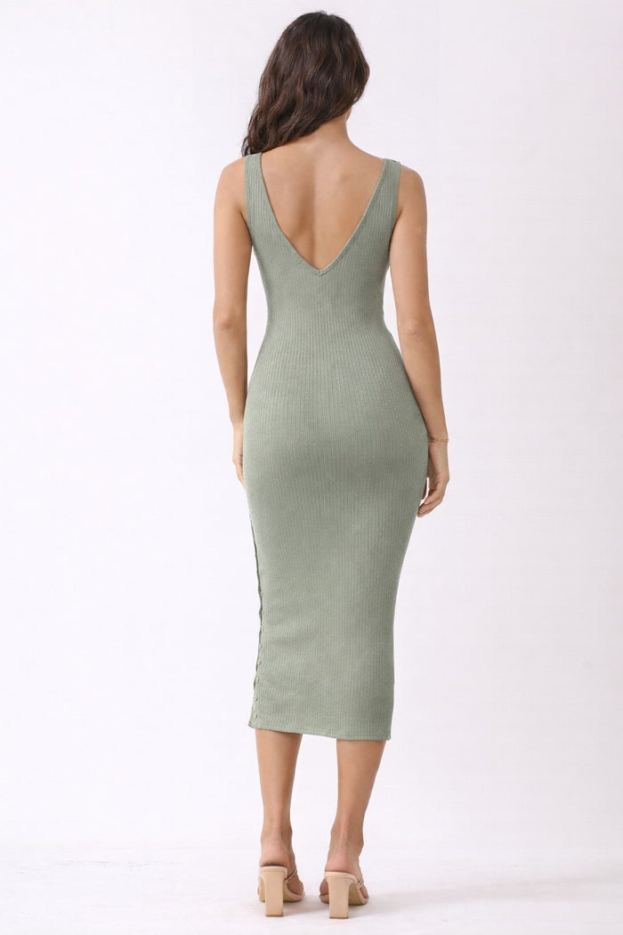 woman wearing a ribbed olive green midi dress with a deep v-back and side slit, styled with open-toe heels