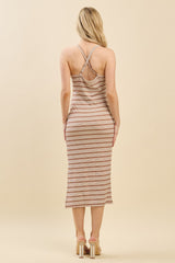 woman wearing a back view of a striped midi dress with crisscross straps and a fitted silhouette