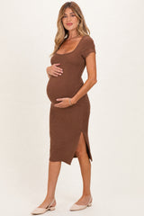 woman wearing a brown ribbed maternity dress with short sleeves and a side slit, showing a baby bump