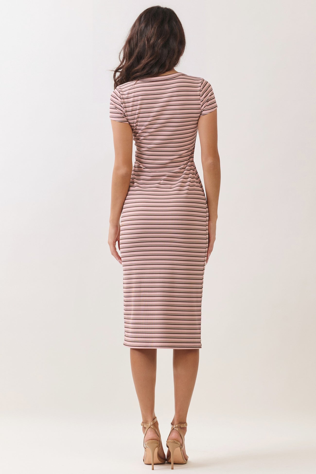 woman wearing a brown and white striped fitted midi dress with short sleeves, viewed from the back