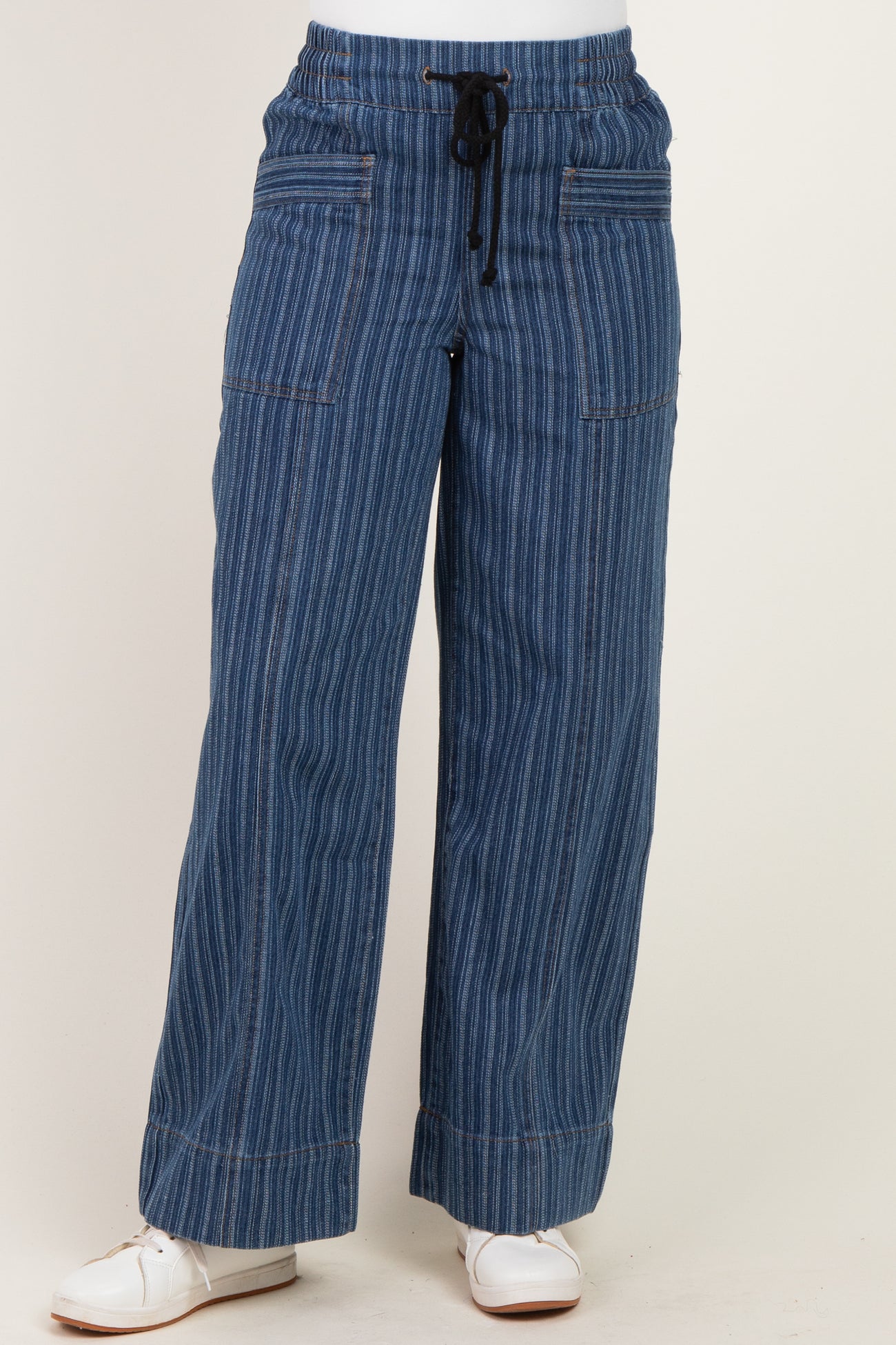 woman wearing blue striped wide-leg denim pants with an elastic waistband and drawstring details
