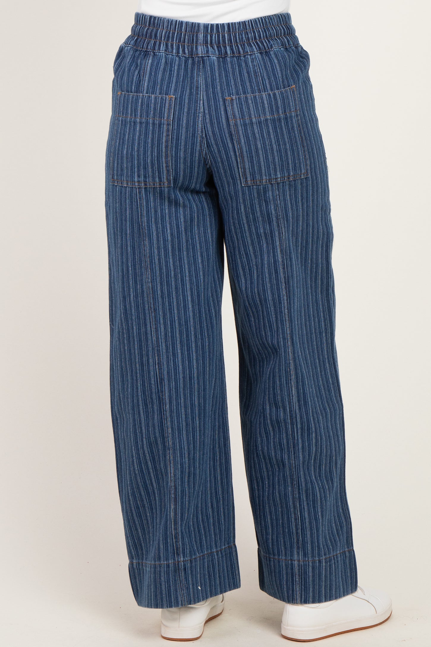 woman wearing blue striped wide-leg pants with an elastic waistband and back pockets