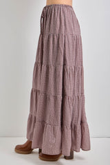 long tiered maxi skirt in a brown and white gingham pattern with an elastic waistband and side ties