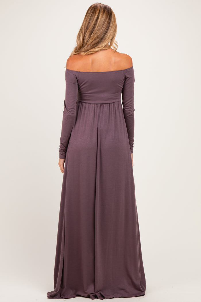 woman wearing a long mauve off-shoulder maternity gown, showing a flowing silhouette from the back