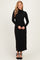 woman wearing a black long sleeve ribbed maxi dress with a high neckline