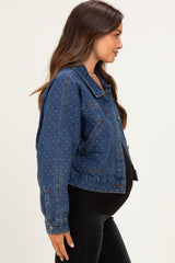 woman wearing a dark blue maternity denim jacket with subtle pattern, showing her baby bump on the side