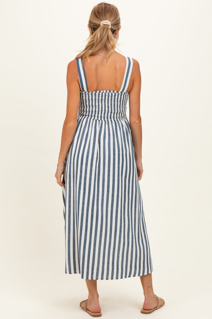 woman wearing a blue and white striped maternity maxi dress with a smocked back and wide straps