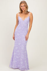 woman wearing a lavender floral print evening gown with a fitted silhouette and spaghetti straps