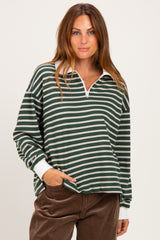 woman wearing a dark green and white striped long sleeve quarter zip top with a relaxed fit and white collar
