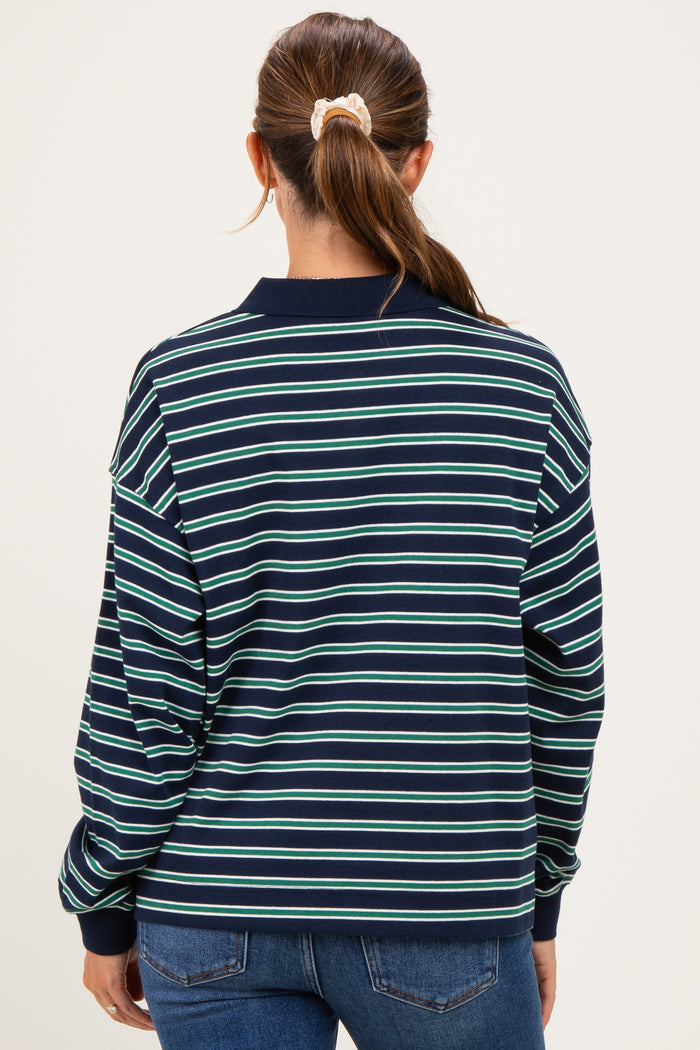 woman wearing a navy blue and green striped maternity sweatshirt, seen from the back