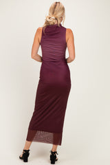 woman wearing a back view of a burgundy sleeveless maxi dress with a fitted silhouette and sheer hem