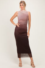 woman wearing a sleeveless ombre maxi dress transitioning from light brown to dark brown, posing with one hand on her hip