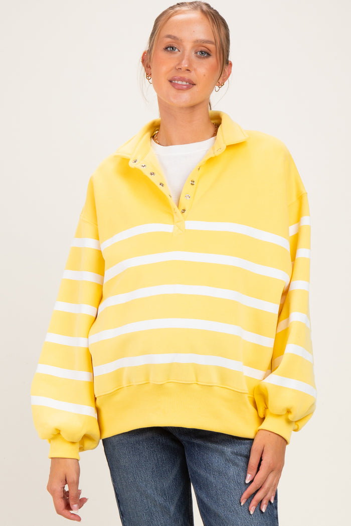 woman wearing a yellow and white striped maternity sweatshirt with a collared neckline and balloon sleeves