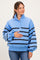 woman wearing a blue striped maternity sweatshirt with a quarter-zip and holding her baby bump