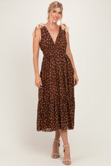 woman wearing a brown polka dot maxi dress with tie straps and a tiered skirt, styled with beige heels