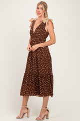 woman wearing a brown polka dot midi dress with ruffled tiers and tied shoulder straps