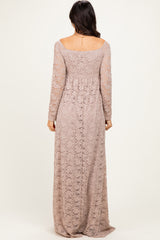 woman wearing a long lace mauve dress with long sleeves and a fitted bodice, shown from the back
