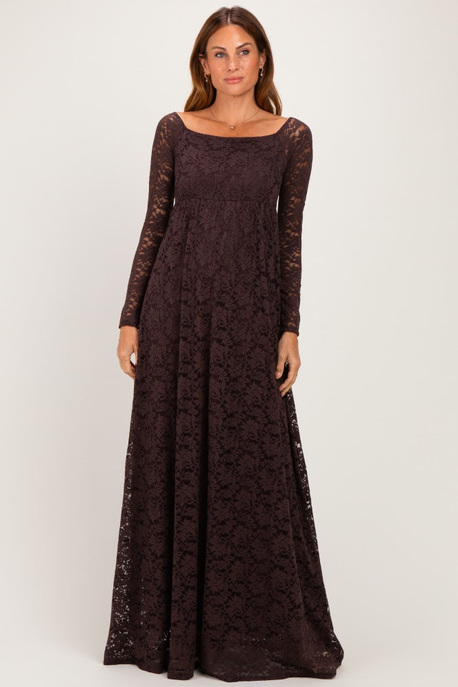 woman wearing a long sleeve dark brown lace maxi dress with a fitted bodice and flowing skirt