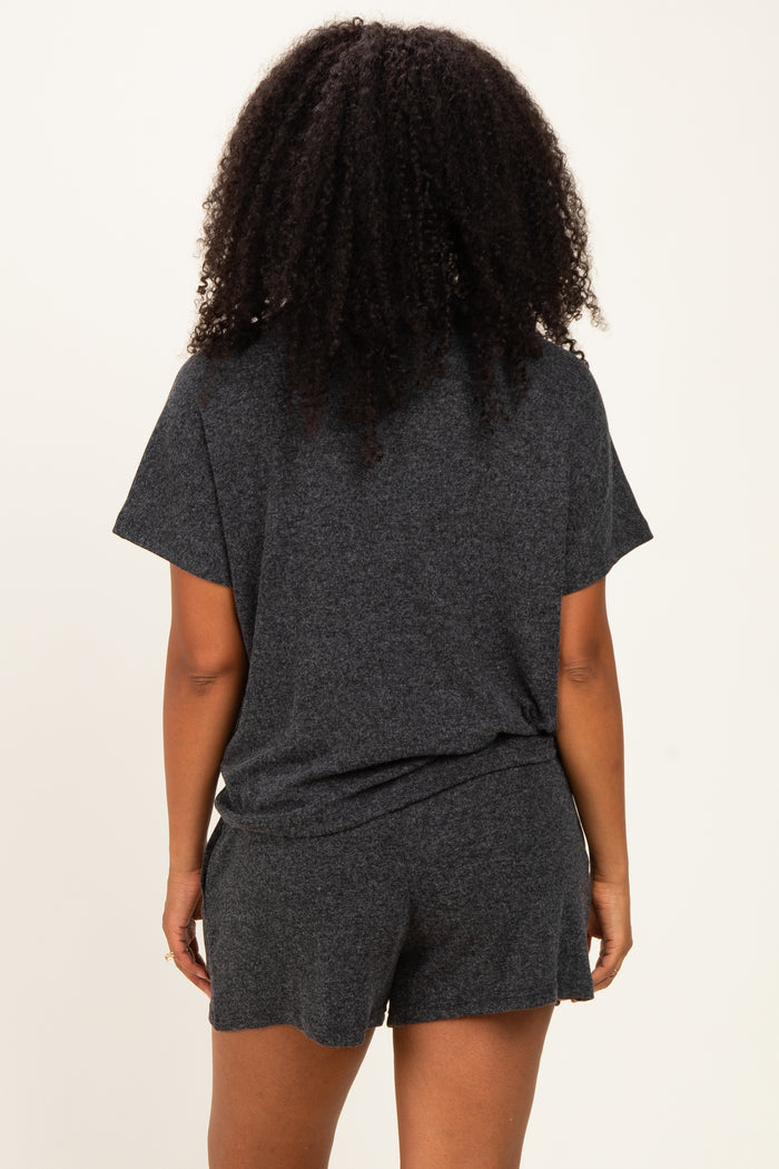 woman wearing a gray short sleeve loungewear set, showing the back view with a relaxed fit and comfortable shorts
