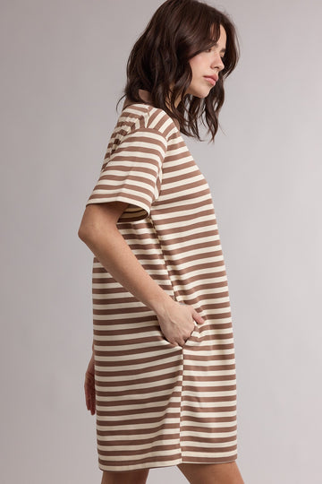 woman wearing a brown and beige striped short sleeve oversized dress with side pockets
