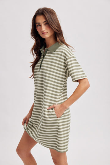 woman wearing a green and white striped polo dress with short sleeves and pockets