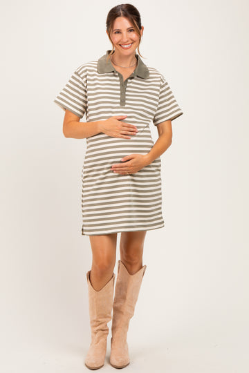 woman wearing a striped maternity polo dress in beige and green, smiling and holding her baby bump