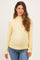 woman wearing a yellow striped maternity top with long sleeves and a relaxed fit, showing her baby bump