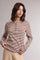 woman wearing a brown and beige striped long sleeve henley top with button details