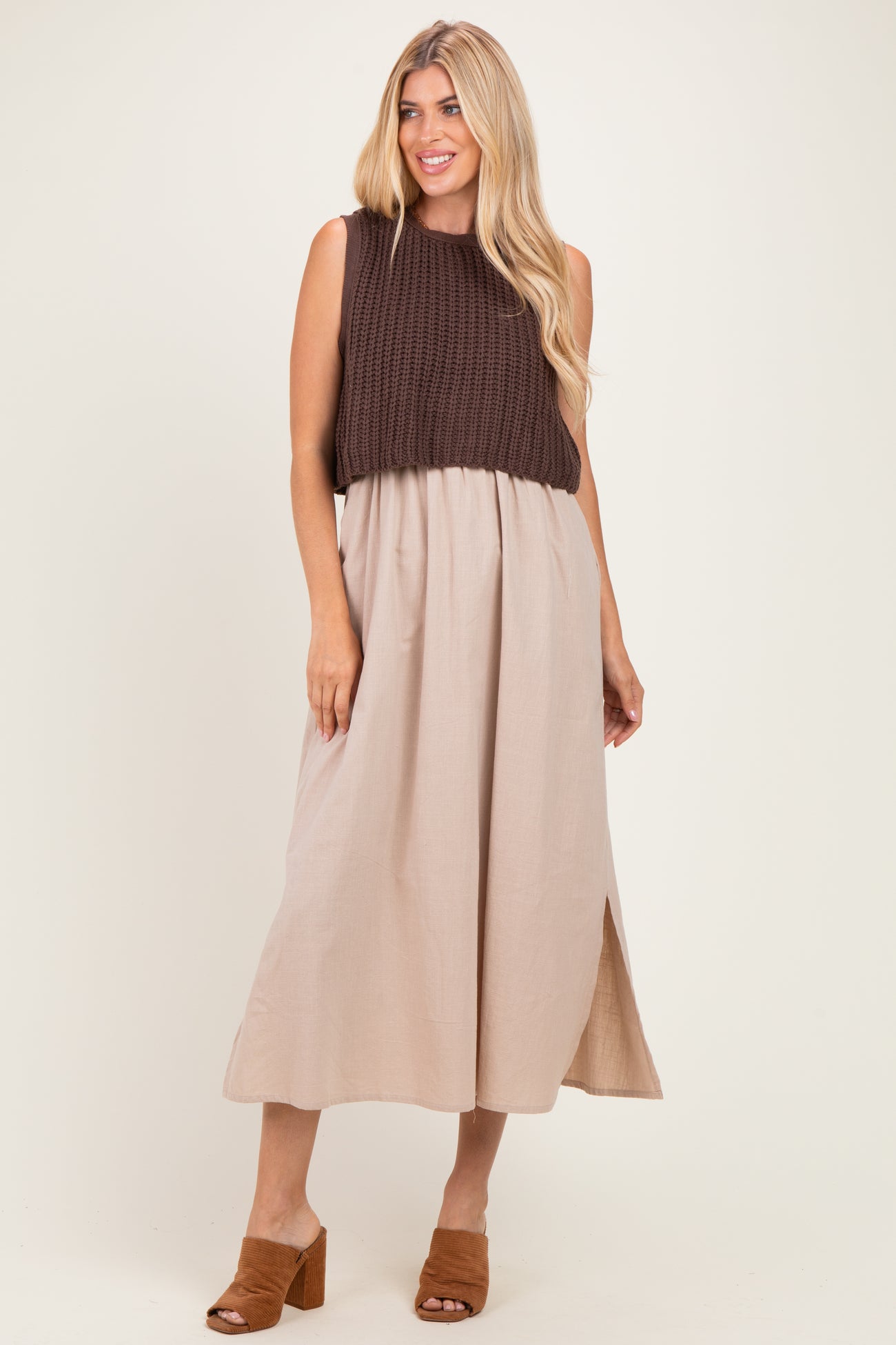 woman wearing a brown knitted sleeveless top with a beige maxi skirt and brown heeled mules