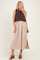 woman wearing a brown knitted sleeveless top with a beige maxi skirt and brown heeled mules
