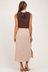woman wearing a brown knit sleeveless maternity dress with a beige skirt and open back detail