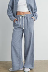woman wearing blue and white checked wide-leg pants with drawstring waist and pockets