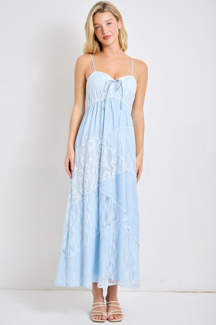 woman wearing a light blue maxi dress with lace details and adjustable spaghetti straps