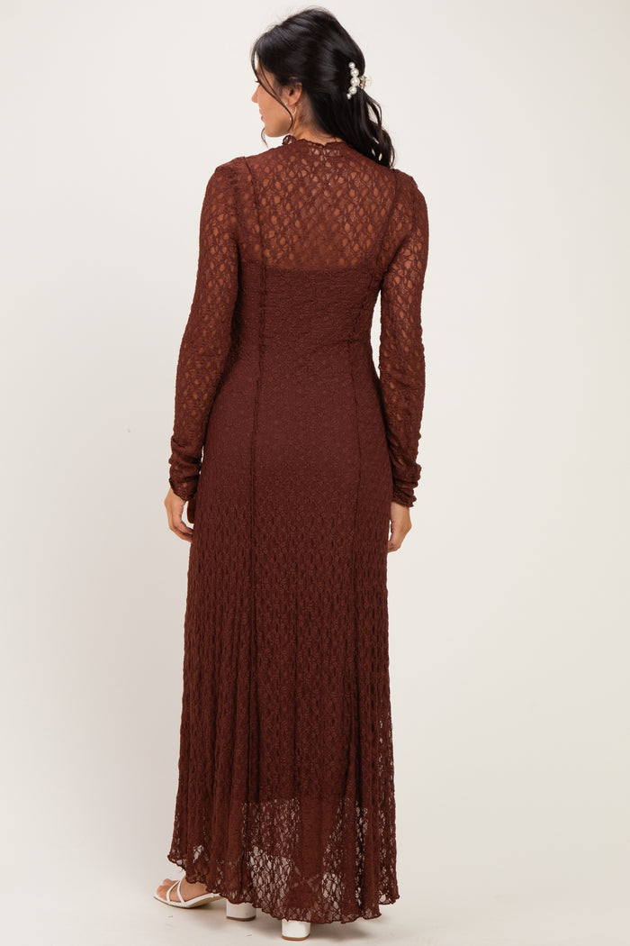 woman wearing a long rust-colored lace maxi dress with long sleeves and a fitted silhouette