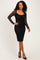 woman wearing a black lace long sleeve dress with a fitted silhouette and a scoop neckline, posing confidently