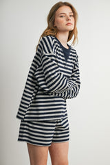 woman wearing a navy and white striped long sleeve top and matching shorts with a relaxed fit