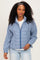 woman wearing a blue and white checkered zip-up jacket and light blue jeans