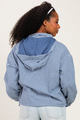 woman wearing a blue and white gingham check hooded jacket, viewed from the back