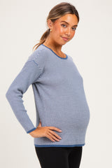 woman wearing a navy and white striped maternity top with a visible baby bump